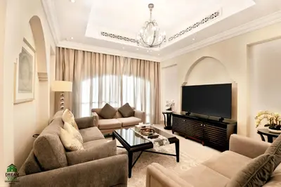 a living room with a couch and a tv at Full View Burj Khalifa and Fountains -Souk Al Bahar- Dream View holiday Home Rent in Dubai