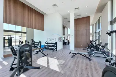 a gym with a bunch of treadmills and exercise bikes at Sleek Modern Studio with Direct view of Dubai Skyline - Farhad Azizi Residence, Al Jaddaf by Deluxe Holiday Homes in Dubai