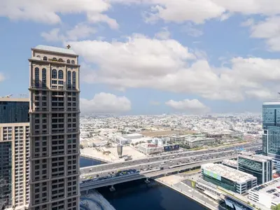 a view of a city with a bridge and buildings at Cozy and Elegant 1 BDR In Noura Tower-37 in Dubai