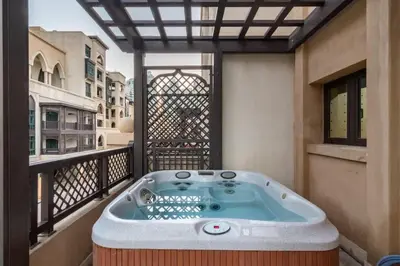a jacuzzi tub on the balcony of a building at Luxury Old Town Fountain View 2BHK front of Dubai Mall in Dubai