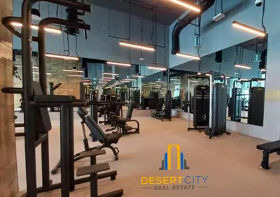 a gym with several treadmills and cardio equipment at Premium 2BR Downtown Dubai Near Burj & Dubai Mall Hosted by Desert City Stays in Dubai