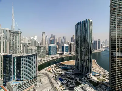 an aerial view of a city with tall buildings at Stunning High-Floor 1BR Burj Khalifa & Canal Views in Dubai