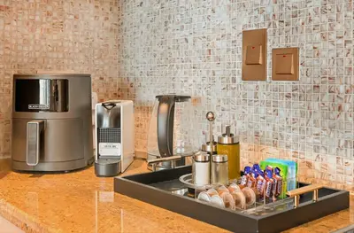a kitchen counter with a sink with a coffee maker at Curated High-Floor 2BR Sofa Bed Marina Water View in Dubai