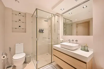 a bathroom with a toilet and a sink and a shower at Curated High-Floor 2BR Sofa Bed Marina Water View in Dubai