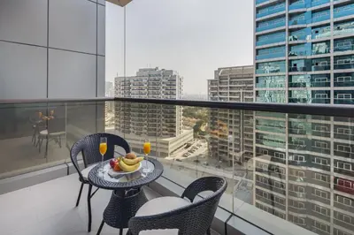 a balcony with a table with a bowl of fruit on it at Chic Studio in Sports City Pool, Gym, Sauna in Dubai