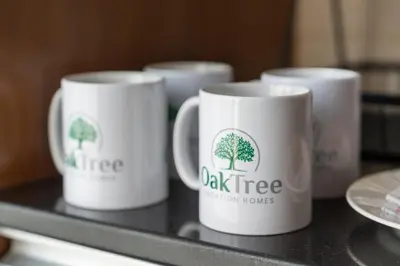 four coffee mugs with trees on them on a tray at Chic Studio in Sports City Pool, Gym, Sauna in Dubai