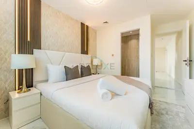 a bedroom with a large white bed and a bathroom at Walking Distance To JBR Beach, The Walk, And Marina Mall, With Easy Access To The Metro And The Vibrant Marina Nightlife - DEC Towers 2, Dubai Marina by Deluxe Holiday Homes in Dubai