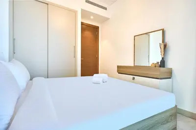 a bedroom with two beds and a mirror at STAY BY LATINEM Luxury 1BR Holiday Home CVR A2604 near Burj Khalifa in Dubai