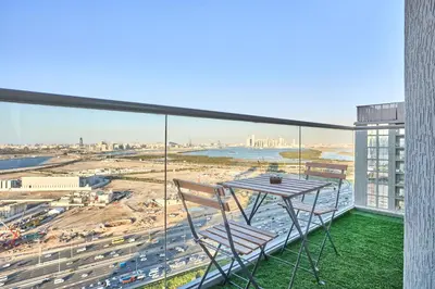 a table and chairs on a balcony with a view at STAY BY LATINEM Luxury 1BR Holiday Home CVR A2604 near Burj Khalifa in Dubai