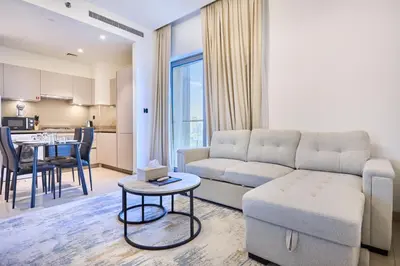 a living room with a couch and a table at STAY BY LATINEM Luxury 1BR Holiday Home CVR A2604 near Burj Khalifa in Dubai