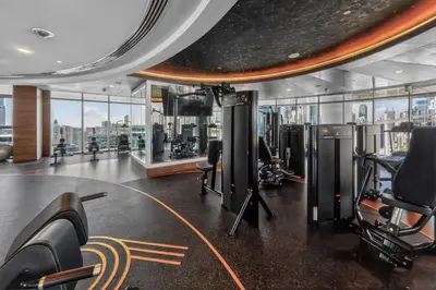 a gym with treadmills and exercise equipment in a building at New Downtown Bldg Near Burj View with Infinity Pool and SkyGym in Dubai