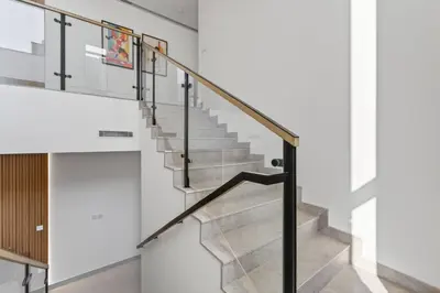 a staircase in a house with stainless steel railings at New, Bright & Modern 4BR Villa in Tilal Al Furjan in Dubai