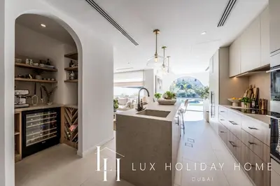 a kitchen with an archway and a sink and a counter at LUX The Serene Springs Villa 3 in Dubai