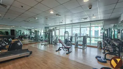 a gym with cardio equipment and a large window at Vogue JLT Lake City Tower near Marina and JBR, Studio Apartment with Lake and City Skyline View, Access to all Amenities in Dubai