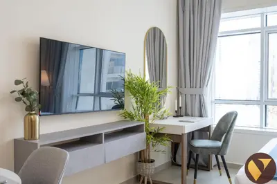 a living room with a desk and a mirror at Vogue JLT Lake City Tower near Marina and JBR, Studio Apartment with Lake and City Skyline View, Access to all Amenities in Dubai
