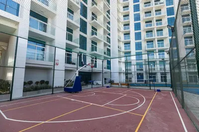 a basketball court in a building with a basketball hoop at Stylish Studio Apartment Skyz by Danube in Dubai