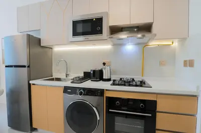 a small kitchen with a stove and a microwave at Stylish Studio Apartment Skyz by Danube in Dubai