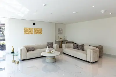 a living room with two couches and a table at Stylish Studio Apartment Skyz by Danube in Dubai