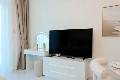 a living room with a flat screen tv on a wall at Stylish Studio Apartment Skyz by Danube in Dubai