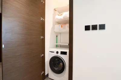 a washer and dryer in a small room at Stylish & Chic 1BR - The Crest at Sobha Hartland in Dubai