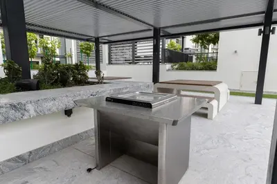 an outdoor patio with a table and a bench at Stylish & Chic 1BR - The Crest at Sobha Hartland in Dubai