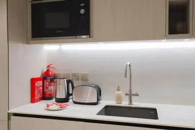 a kitchen counter with a sink and a microwave at Gracious Studio in Pearl House by Imtiaz in Dubai