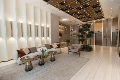 a lobby with a white couch and chairs and tables at Gracious Studio in Pearl House by Imtiaz in Dubai