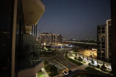 a view of a city street at night with buildings at Modern and cozy studio apartment in Dubai