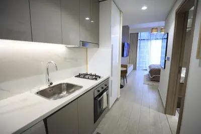 a kitchen with a sink and a stove top oven at Modern and cozy studio apartment in Dubai