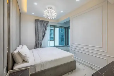 a bedroom with a bed and a chandelier at Spacious 2 BDR apartment in Downtown Dubai I 29 Blvd in Dubai