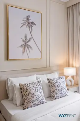 a bedroom with a bed with a picture of palm trees at Tranquil Boho 1BR in Surf 2 Creek Beach Access in Dubai