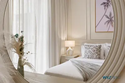 a bedroom with a bed and a mirror at Tranquil Boho 1BR in Surf 2 Creek Beach Access in Dubai