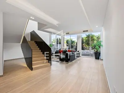 a living room with a staircase in a house at Luxury Ixora Family Villa in Dubai