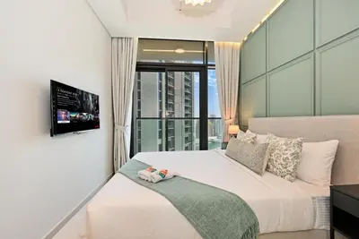 a bedroom with a large bed and a window at High Floor 2 Bedroom Apartment - Exclusive Luxury at Aykon Tower - PlayStation 5 in Dubai