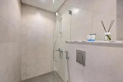 a bathroom with a shower with a glass door at High Floor 2 Bedroom Apartment - Exclusive Luxury at Aykon Tower - PlayStation 5 in Dubai