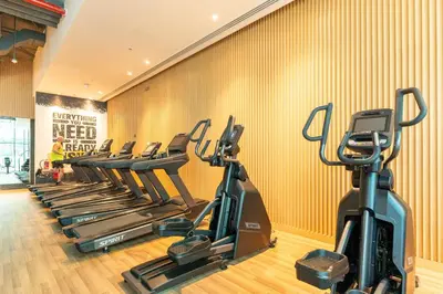 a row of exercise bikes in a gym at Luxury Studio with Private Beach Access - Palm Jumeirah in Dubai