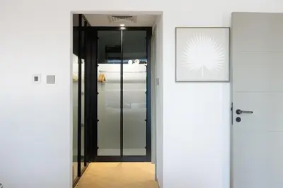 a hallway with a door and a picture on the wall at Newly Upgraded 2BR - Steps from Burj Khalifa and Opera in Dubai