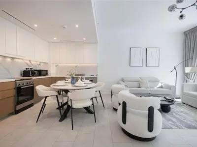 a kitchen and living room with a table and chairs at La Vie Seaside with Beach Access in Dubai