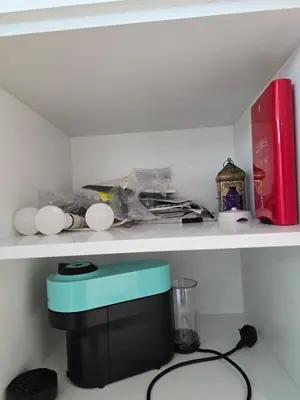 a shelf with a black and blue box on it at Luxury 1BR with Scenic Views - Palace Residence in Dubai