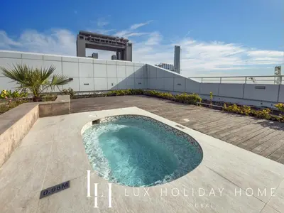 a swimming pool on the roof of a building at LUX The JLT Gold Crest Suite in Dubai