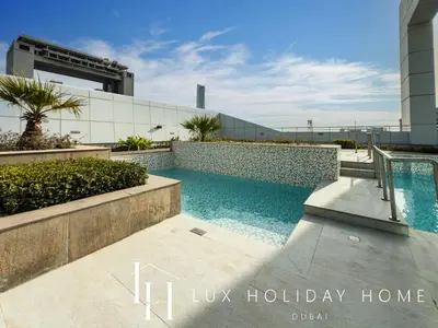 a swimming pool in front of a building at LUX The JLT Gold Crest Suite in Dubai