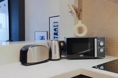 a kitchen counter with a microwave and a toaster at 904 DAMAC Paramount in Dubai