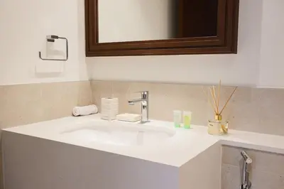 a bathroom with a white sink and a mirror at Lux 2BR Beachfront Escape Palace Beach Residence in Dubai