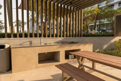 a outdoor kitchen with a sink and a wooden bench at Lux 2BR Beachfront Escape Palace Beach Residence in Dubai