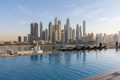 a view of a city skyline with a large pool at Lux 2BR Beachfront Escape Palace Beach Residence in Dubai
