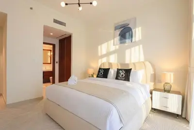 a bedroom with a large white bed with two pillows at Lux 2BR Beachfront Escape Palace Beach Residence in Dubai