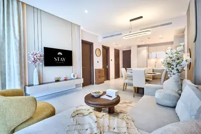 a living room with a couch and a table at STAY BY LATINEM Luxury 1BR Holiday Home CVG2403 Near Downtown in Dubai