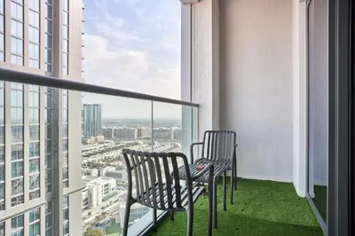 two chairs on a balcony with a view of a city at STAY BY LATINEM Luxury 1BR Holiday Home CVG2403 Near Downtown in Dubai