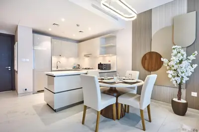 a kitchen and dining room with a table and chairs at STAY BY LATINEM Luxury 1BR Holiday Home CVG2403 Near Downtown in Dubai