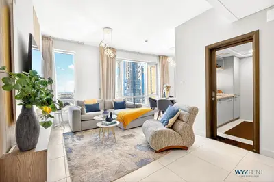 a living room with a couch and a table at Upscale 1BR Loft Central Walk to Burj Khalifa&Mall in Dubai